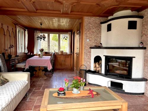 a living room with a fireplace and a table at Engelberg, Renovated Chalet in Wonderful Location in Engelberg