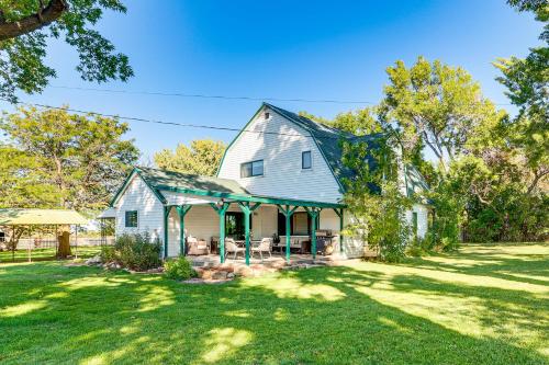 a white house with a green roof at Patio and Mountain Views Farmhouse in Mancos! in Mancos