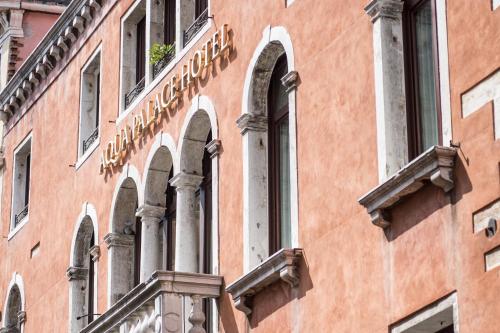 a building with a sign on the side of it at Aqua Palace in Venice
