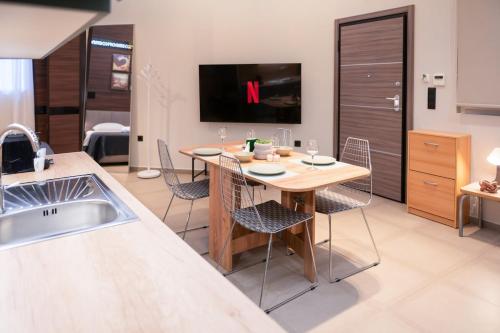 a kitchen with a table and chairs in a room at Evis Cosmos 1 - Meno Homes 10 in Xanthi