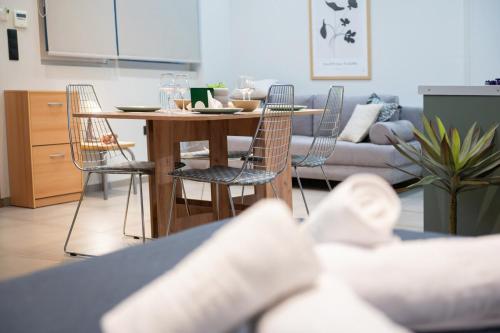 a living room with a table and chairs and a couch at Evis Cosmos 1 - Meno Homes 10 in Xanthi