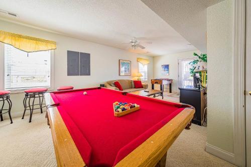 a living room with a pool table in front of it at Shell Town in Nags Head