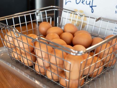 a metal basket filled with eggs on a table at ibis Paris 17 Clichy-Batignolles in Paris