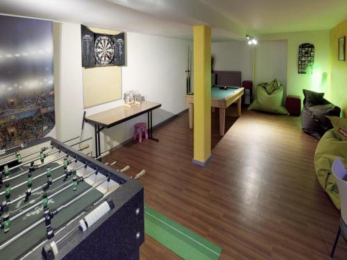 a room with a pool table and a living room at ibis Styles Louvain-la-Neuve Hotel and Events in Louvain-la-Neuve