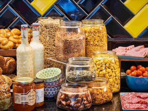 a table with many jars of different types of food at Mercure Paris Gare De Lyon TGV in Paris