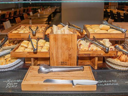 a display of breads and pastries in wooden boxes at ibis Sao Paulo Barra Funda in Sao Paulo