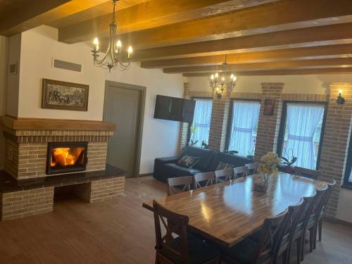 a living room with a table and a fireplace at Iedera Bucovinei in Suceviţa