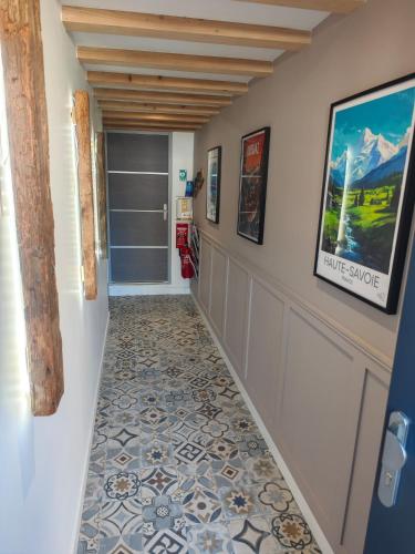 a hallway with a tile floor in a house at Un Coin De Gîtes in Sciez