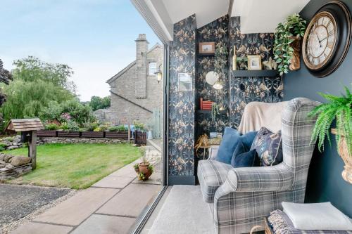 a living room with a clock on the wall at 1 Bed in Askrigg oc-c33109 in Askrigg