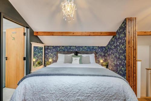a bedroom with a large bed and a chandelier at 1 Bed in Askrigg oc-c33109 in Askrigg
