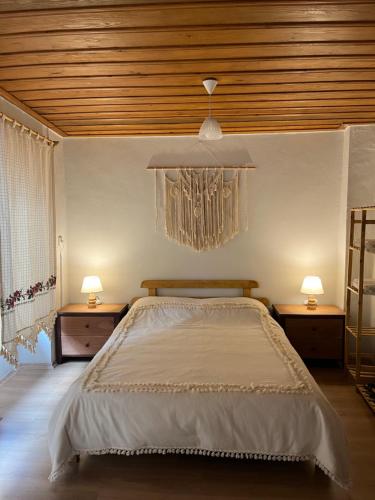 a bedroom with a large bed and two night stands at Ayvalık Sezer Konukevi in Ayvalık