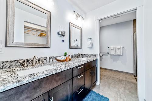 a bathroom with two sinks and a mirror at Serenity at Deerhaven #A in Gold Beach