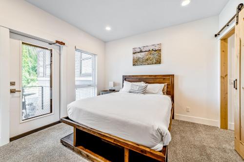 a bedroom with a large bed and a window at Serenity at Deerhaven #A in Gold Beach