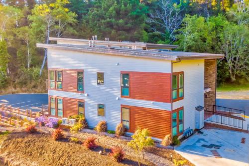 an aerial view of a house with a porch at Serenity at Deerhaven #A in Gold Beach