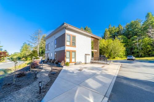 a large white house with a driveway at Serenity at Deerhaven #A in Gold Beach