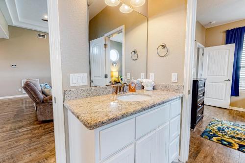 a bathroom with a sink and a mirror at Ultimate Steps to Beach Large Deck Dog Haven in Crystal Beach