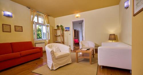 a living room with a couch and chairs and a table at Appartamenti Palazzo Lantieri in Gorizia
