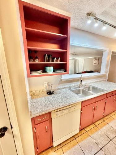 a kitchen with red cabinets and a sink at Home Away from Home in Fitzgerald