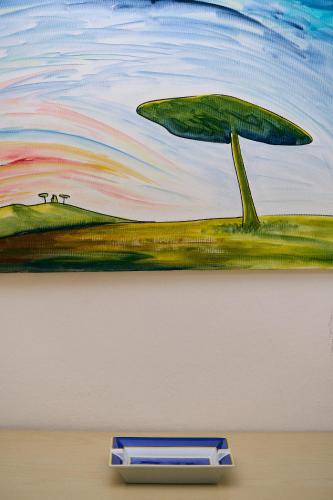 a painting of a tree on a wall at Appartamenti Palazzo Lantieri in Gorizia