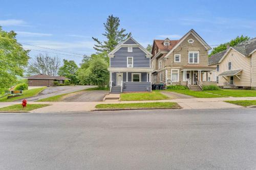 a row of houses on a street with a fire hydrant at Pitcher's Paradise Apt 2-All Star Baseball Rentals in Oneonta