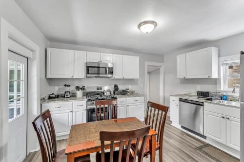 a kitchen with white cabinets and a table and chairs at Pitcher's Paradise Apt 3 All Star Baseball Rentals in Oneonta