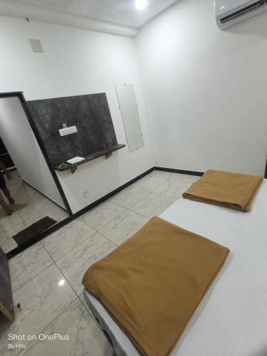 a room with two beds and a chalkboard on the wall at Dwarka Sai Palace in Dwarka