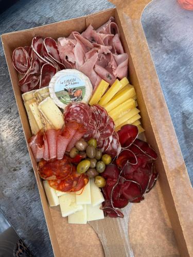 a box filled with different types of meats and cheese at Chambre d hôte Lavande "Au fond du jardin" in Saint-Saturnin-lès-Avignon