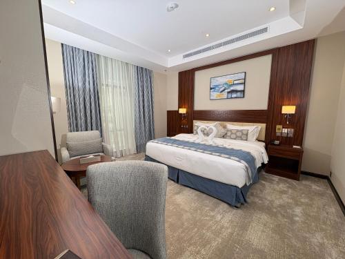 a hotel room with a bed and a table and chairs at mawasim al hay at hotel in Jeddah