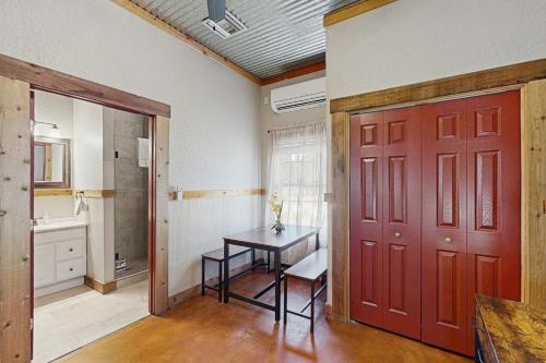 a room with a table and a red door at Historic Rocky Hill- Full Property in Fredericksburg