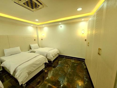 Llit o llits en una habitació de الربيعي للشقق الفندقية 200متر عن الحرم