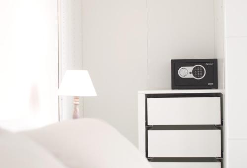 a bedroom with a bed and a radio on a shelf at The Riverside Suite in Mira