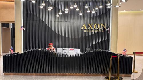 a man is sitting at a desk in a building at Axon Residence Pavilion Bukit Bintang SkyView in Kuala Lumpur