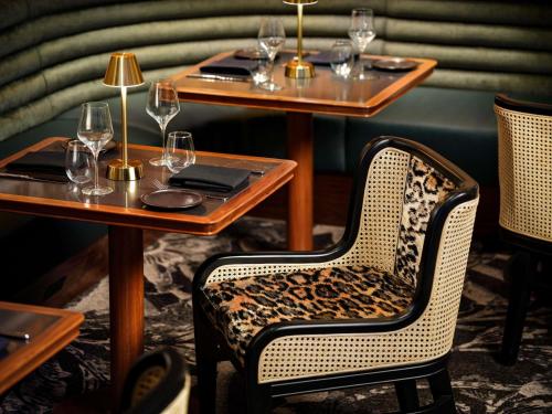 a restaurant with two tables and chairs with wine glasses at Sofitel Philadelphia at Rittenhouse Square in Philadelphia