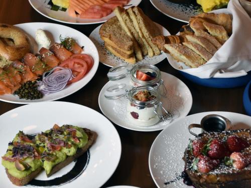a table topped with plates of food and bread at Sofitel Philadelphia at Rittenhouse Square in Philadelphia