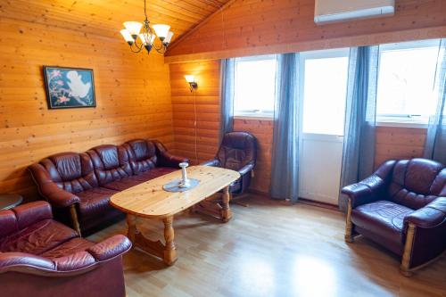 a room with couches and a table and chairs at Skottneset Feriesenter in Barmen