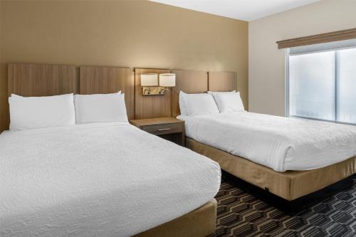 a hotel room with two beds and a window at Best Western Plus Zion Canyon Inn & Suites in Springdale