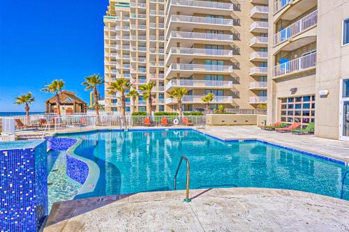 a swimming pool in front of a large apartment building at Escapes to the Shores 1101 in Orange Beach