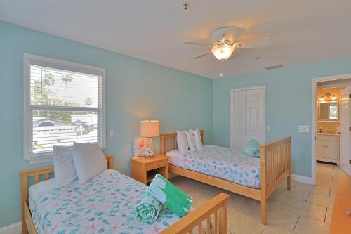 a bedroom with two beds and a window at Siesta Key Island Rentals in Siesta Key