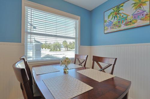 a dining room with a table with chairs and a window at Siesta Key Island Rentals in Siesta Key
