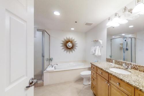 a bathroom with a sink and a toilet and a shower at Escapes to the Shores 1101 in Orange Beach