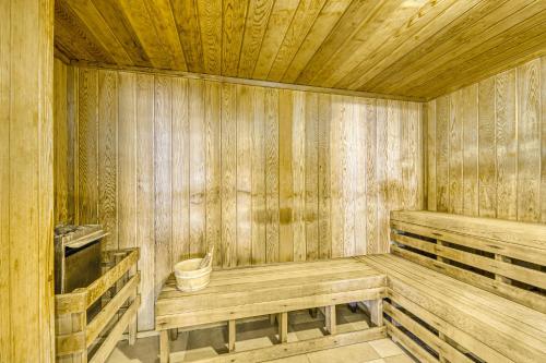 a wooden sauna with a bench and a bucket in it at Escapes to the Shores 1101 in Orange Beach