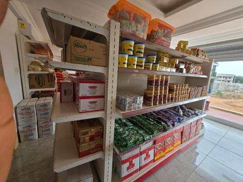 a grocery store aisle with shelves full of food at Hillview Guest House 