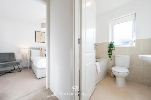 a white bathroom with a toilet and a sink at Stylish 3BED Glan Llyn Retreat - Close to Cardiff & Newport - Parking in Newport