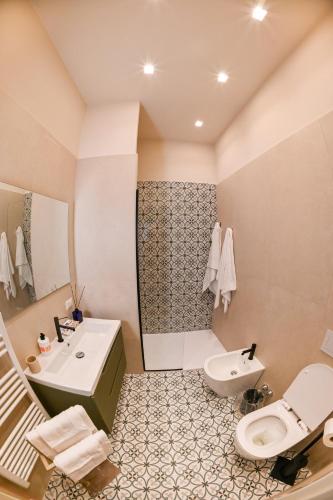 a bathroom with a sink and a toilet and a shower at Nocera House in Nocera Inferiore