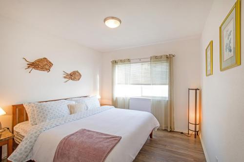una camera da letto bianca con un letto e una finestra di Stunning Oceanview Shelter Cove! by OceanviewHotTubs Oceanfront! Tesla EV station a Shelter Cove