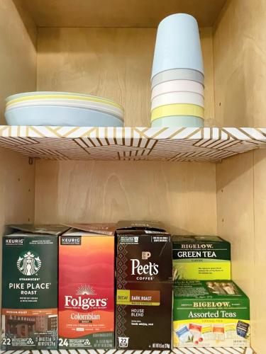a shelf with plates and bowls on it at Comfort Meets Convenience in Schaumburg