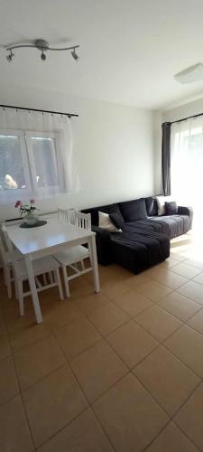 a living room with a couch and a table at Spí v Kuklenách 1 in Hradec Králové
