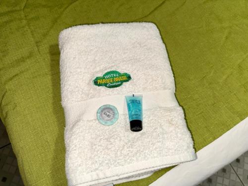 a towel with a tube of toothpaste and a candle on a bed at Hotel Boutique Parque Brasil in Antofagasta