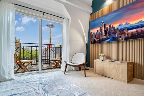 a room with a large window with a view of the city at Designer Penthouse Space Needle View & Walk to Everything in Seattle