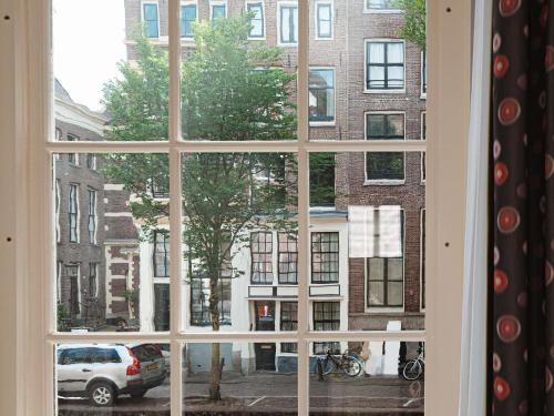 a window with a view of a building at Sofitel Legend The Grand Amsterdam in Amsterdam